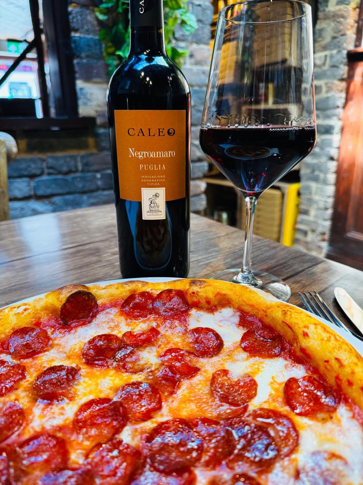 Pepperoni pizza and a glass of wine at Ottimo Pizzeria